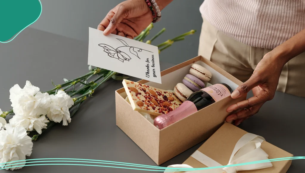 Woman putting postcard into giftbox 